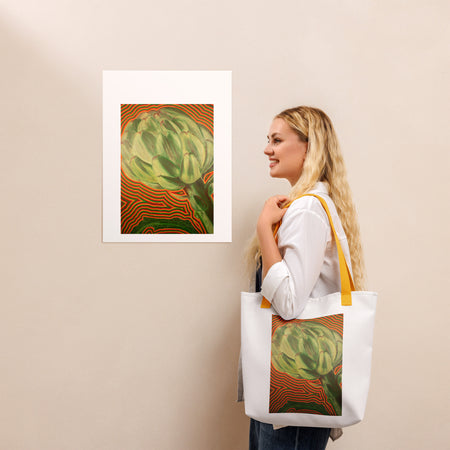 white tote bag with yellow straps and a psychedelic image of an artichoke radiating bands of red, orange, and green color