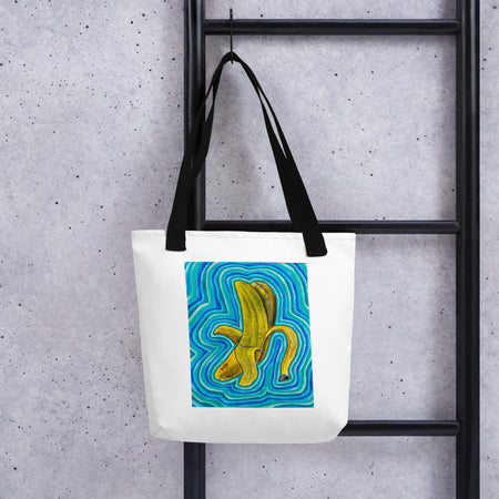 white tote bag with image of a peeled banana radiating aqua and blue colored bands