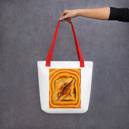 white tote bag with red straps featuring image of a grilled cheese radiating colored bands of red, orange and yellow.