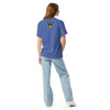 girl wearing a a light blue t-shirt with original art of animal head of wasp face with elephant tusks and trunks, and snake hair, in an ellipse 