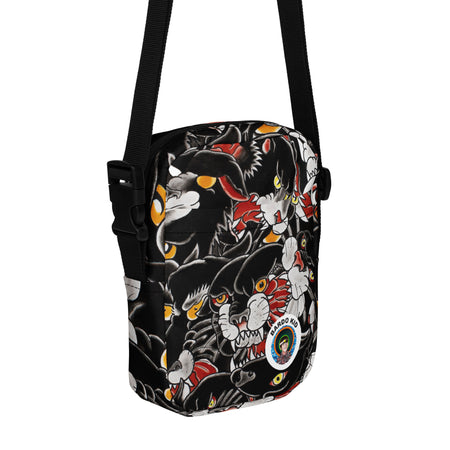 cross body bag with many tattoo styled black panther heads all over it