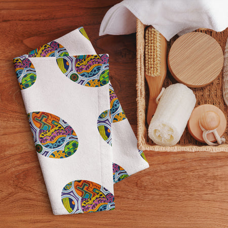 hand towel featuring repeating ovals of multicolored geometric shapes