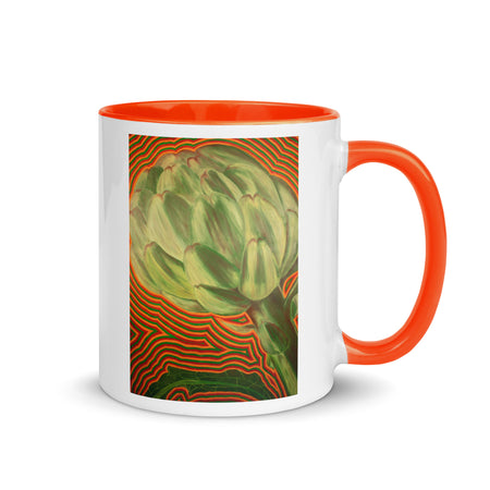 white and orange coffee mug with image of artichoke with colorful lines around it in reds and greens.