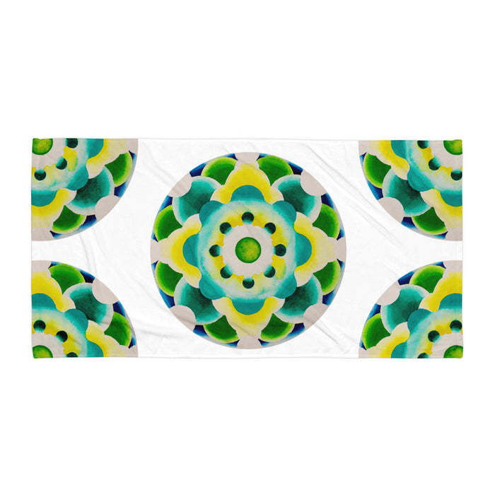 beach towel with a bright nested circle based mandala made up of radiating greens, turquoises, yellow, and blues, resembling a molecule or a dimensional portal.jpg