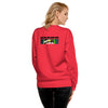 A woman shown from the back wearing a bright red crewneck sweatshirt with a graphic print on the upper back. The graphic features the logo 'BARDO' in black letters above a young boys graphic face.