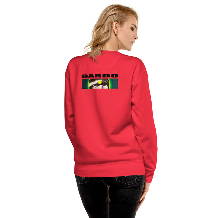 A woman shown from the back wearing a bright red crewneck sweatshirt with a graphic print on the upper back. The graphic features the logo 'BARDO' in black letters above a young boys graphic face.