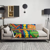 Colorful abstract patterned blanket with vibrant colors on a white background