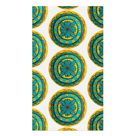 repeating circular floral artwork in turquoises, browns, and yellows on a hand towel
