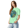 girl wearing a light chartreuse green t-shirt with a circular design of squiggly blue, green, and yellow circular designs