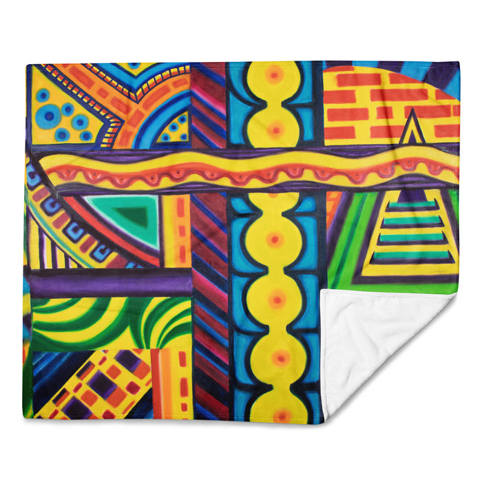 Colorful abstract patterned blanket with vibrant colors on a white background