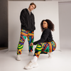 Two people wearing colorful abstract art  pants on a white background