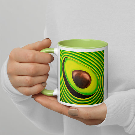 Mug with a psychedelic avocado design held by a hand against a light gray background
