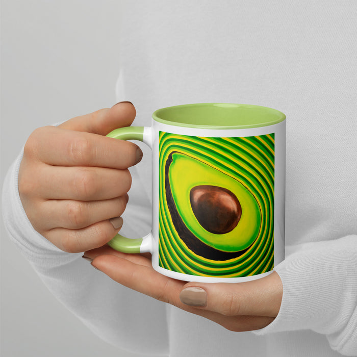 Mug with a psychedelic avocado design held by a hand against a light gray background