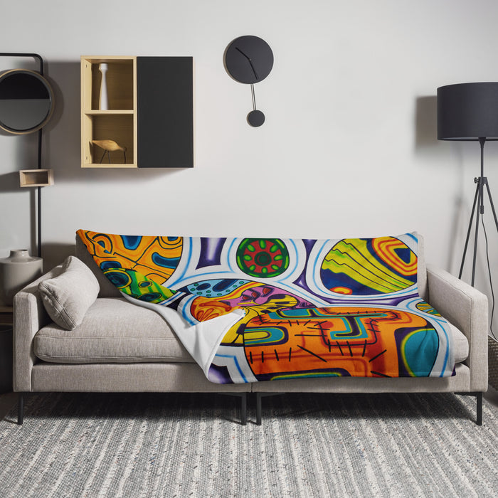 Colorful, psychedelic, abstract patterned blanket on a gray sofa in a modern living room.