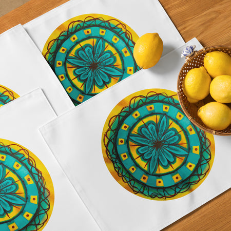 dining placemat set featuring a circular, floral mandala of turquoise, brown, and yellow