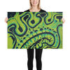 abstract art print in electric lime and blue,, being held up by a person. 24" x 36"