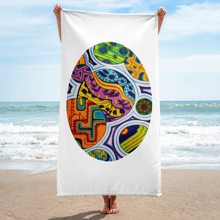 Colorful abstract design towel held by a woman on a beach