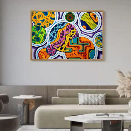 A colorful abstract canvas wall art print with a light wood frame, displayed in a modern living room setting above a beige sofa.