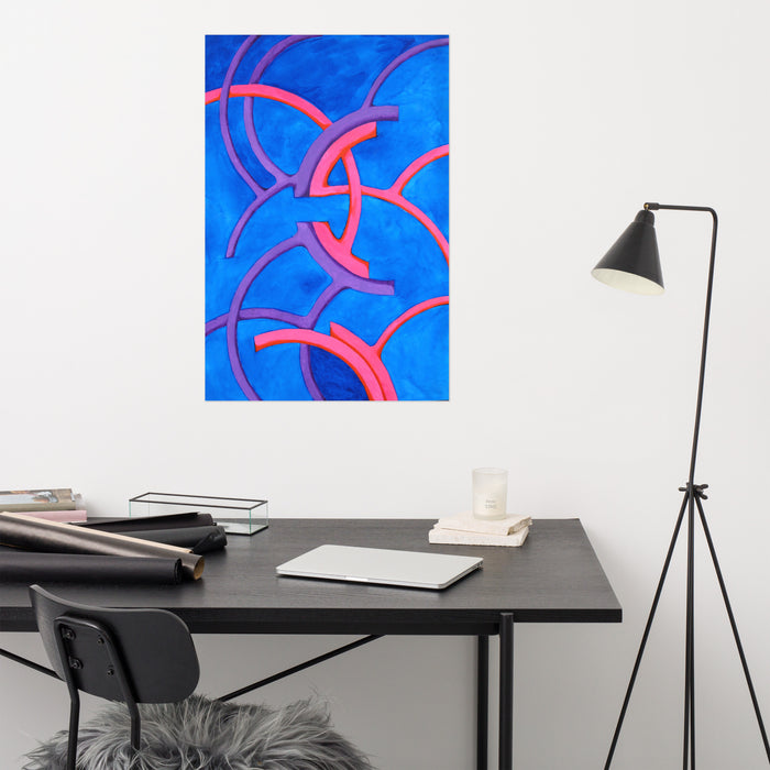 an abstract watercolor in neon pinks and blues composed of tubular forms curving symmetrically with each other hanging on a wall above a desk