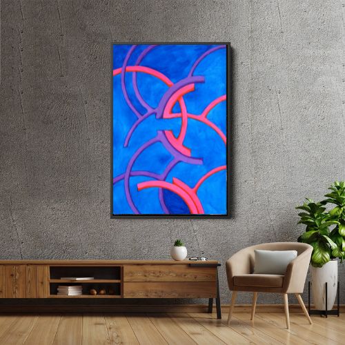 A framed abstract art print featuring vibrant blue, pink, and purple curved lines, displayed on a textured gray wall above a wooden console table in a modern living room setting.