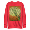 a very bright red orange sweatshirt with an original, full color artichoke radiating psychedelic bands of red, orange, and green around it.