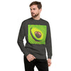 A man wearing a dark gray crewneck sweatshirt with a large, vibrant green and yellow avocado graphic on the chest, set against a plain white background.