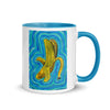white and blue mug with abstract banana artwork