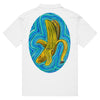 a white polo shirt with the bardo kid logo on the front and a banana on the back radiating psychedelic waves of turquoise, blues, and greens.