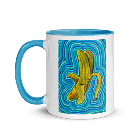 white and blue mug with abstract banana artwork