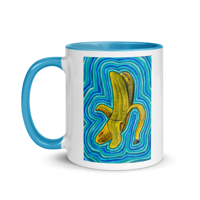white and blue mug with abstract banana artwork