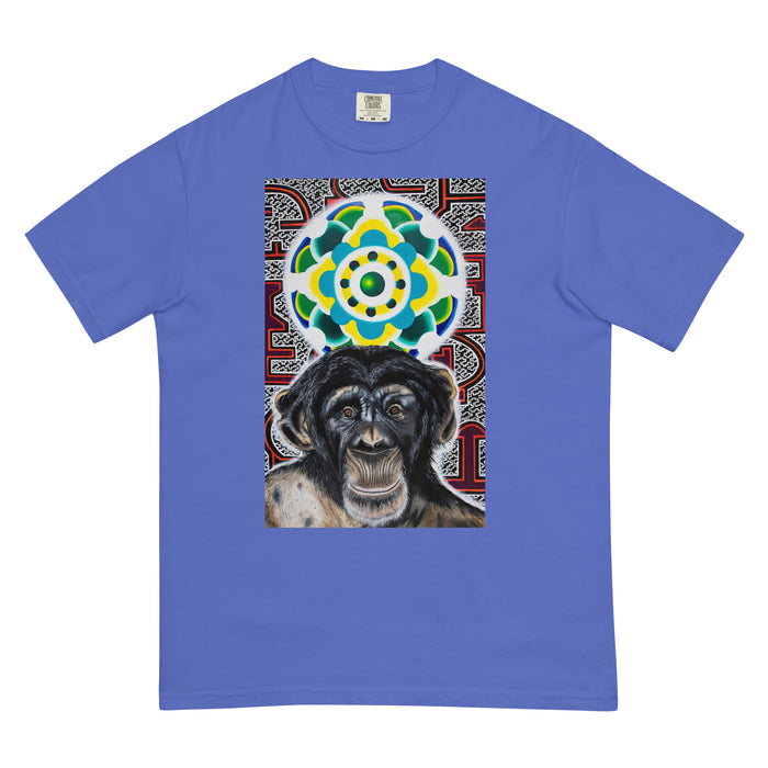 light blue t-shirt with a young chimpanzees face in front of a turquoise, green, and yellow psychedelic mandala with a background illustrated by pulsating geometric red and purple forms