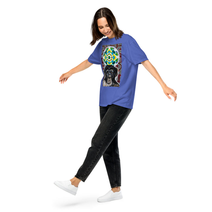 girl wearing a a light blue t-shirt with an image of a young chimpanzees face in front of a turquoise, green, and yellow psychedelic mandala 