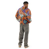 man wearing Colorful graffiti hoodie with spray can style abstract patterns in purples, turquoises and oranges on on a white background