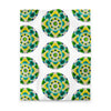 white duvet with an abstract circular repeating pattern made of circles in turquoise, green, and yellow.