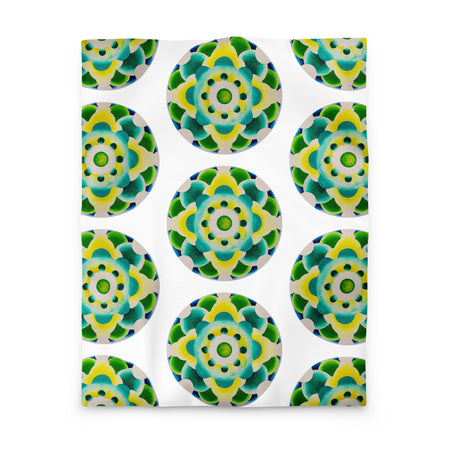 white duvet with an abstract circular repeating pattern made of circles in turquoise, green, and yellow.