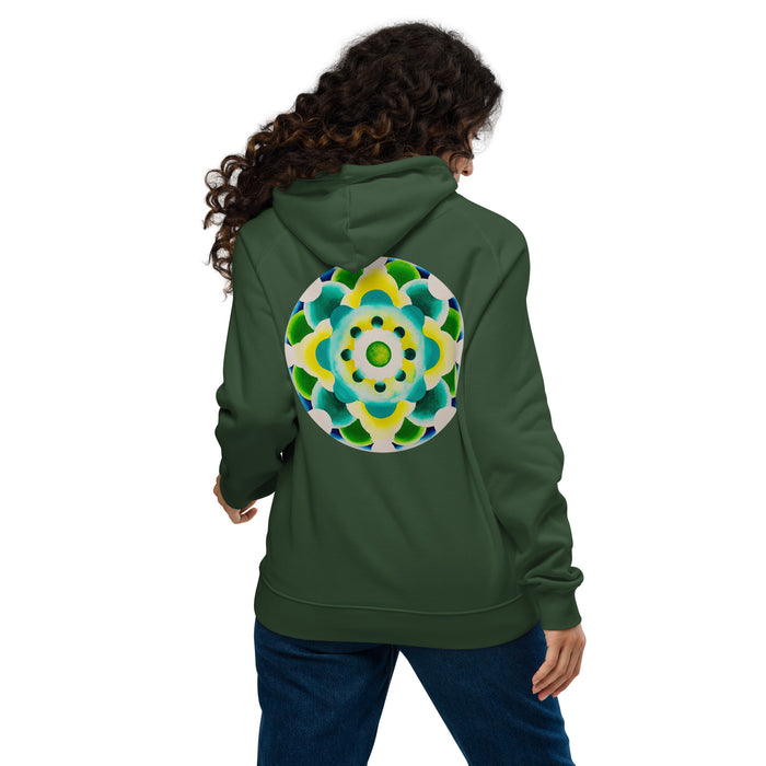 woman wearing a green hoodie with a circular mandala design on the back in greens and yellows