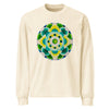 a beige long sleeve t-shirt featuring a green and yellow mandala made up of concentric circles