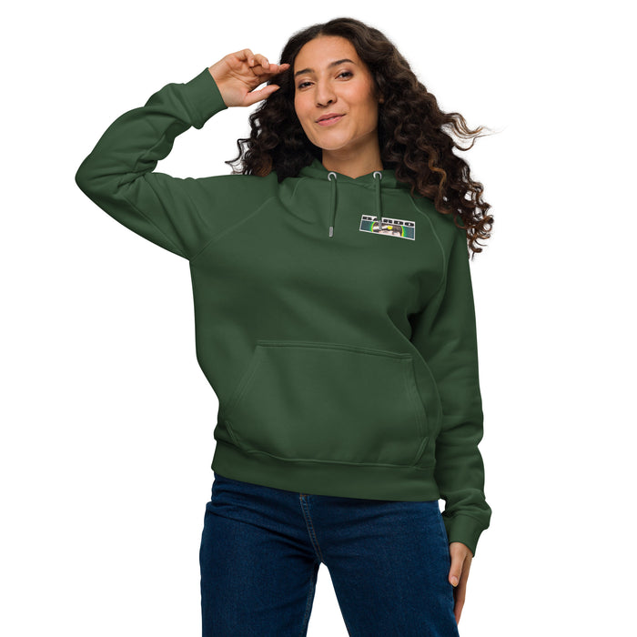 woman wearing a green hoodie with a bardo kid logo on the upper chest of a youn boys face