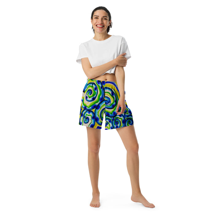 woman wearing athletic shorts with swirling circular abstract patterns of aquas, blues, greens, and yellows