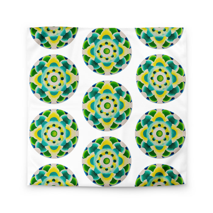 white duvet with an abstract circular repeating pattern made of circles in turquoise, green, and yellow.