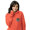 A woman wearing a bright coral-orange pullover hoodie with a colorful 'bardo Kid' graphic on the left chest, set against a plain white background.