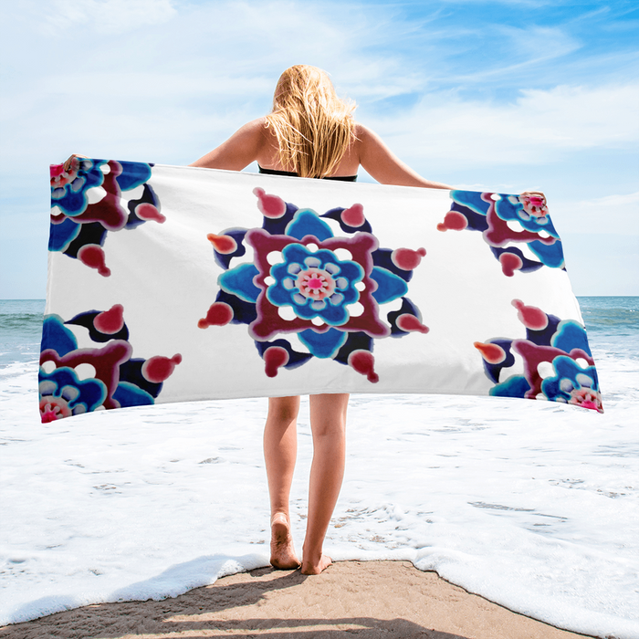 lady holding a beach towel with a watercolor painting mandala made of circles in magentas and blues