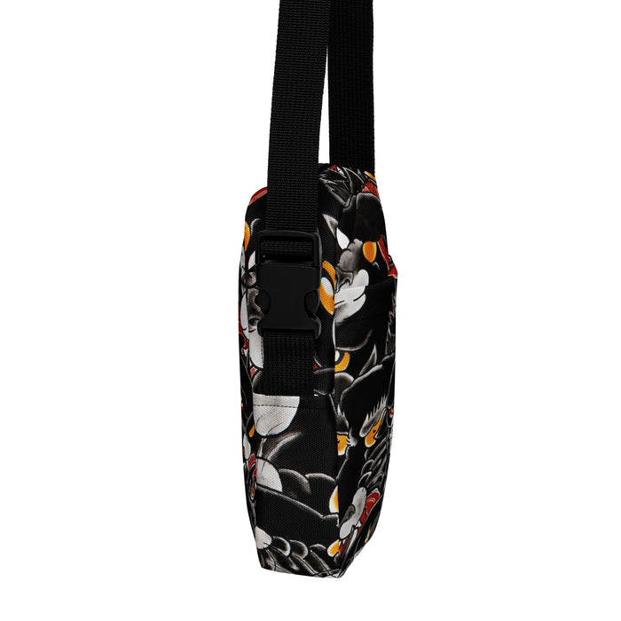 Crossbody bag with a black background and colorful tattoo themed black panther  pattern on a white background