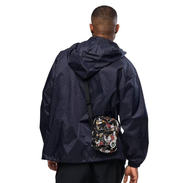 man wearing a crossbody bag with a black background and colorful tattoo themed black panther  pattern on a white background