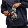 man putting card into a Crossbody bag with a black background and colorful tattoo themed black panther  pattern on a white background