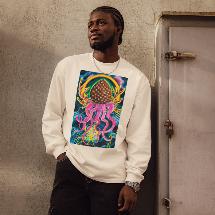 man wearing a beige long sleeve t-shirt with original art depicting a pine cone with dangling octopus tentacles, elk antlers, and a Tibetan halo in front of a stormy lightning filled sky.