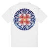 a white polo shirt with the Bardo Kid logo on the front upper right chest and a psychedelic flower design in reds, blues, and oranges on the back.
