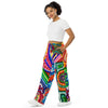woman wearing soft track pants with all over geometric abstract, psychedelic colorful designs.