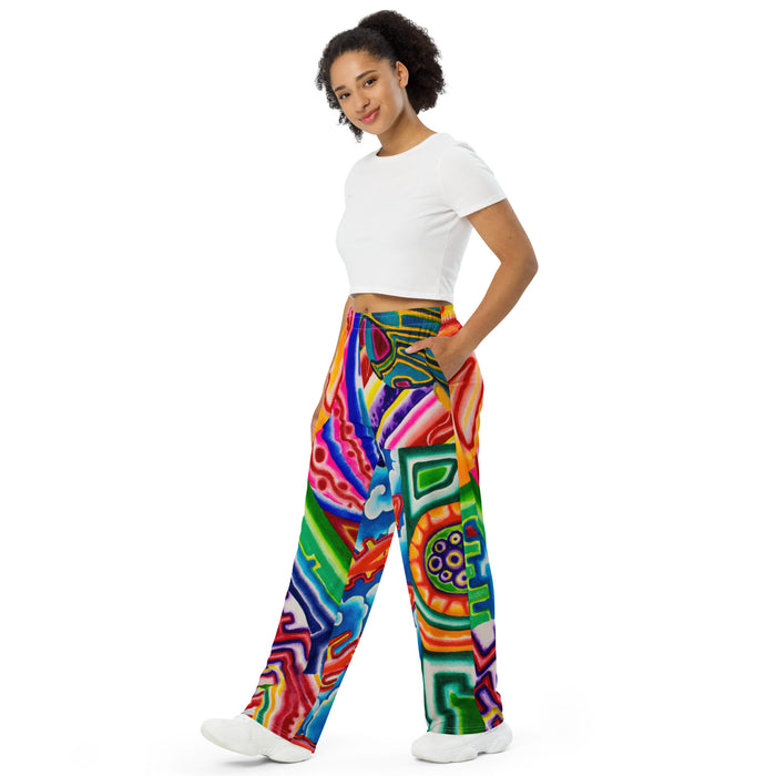 woman wearing soft track pants with all over geometric abstract, psychedelic colorful designs.