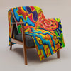 throw blanket with multicolored abstract, geometric imagery